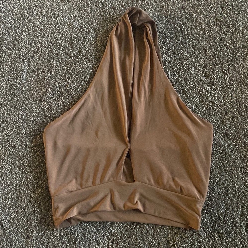 Brown sleeveless top, wraps around neck, open back.